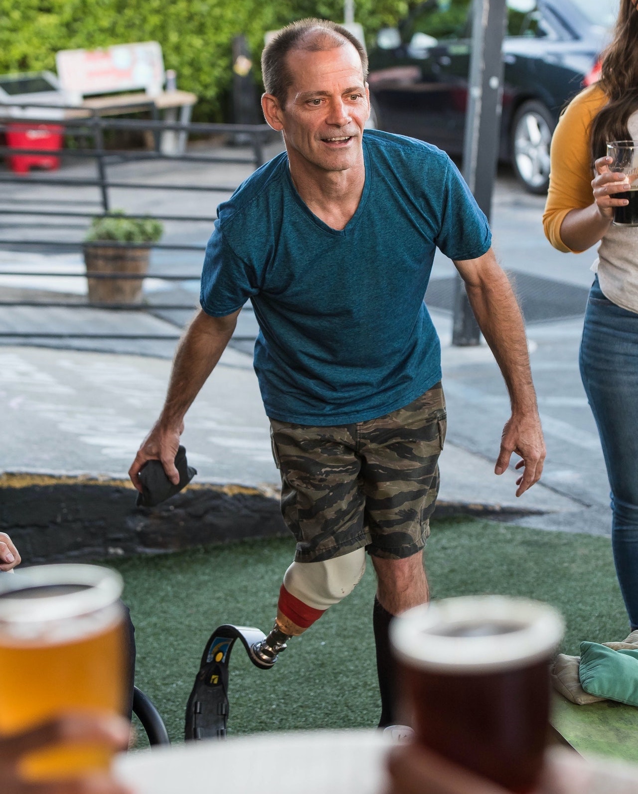 Person with prosthetic leg playing cornhole